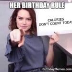 Woman pointing at a sign that says “Calories don’t count today” because it’s her birthday, proving she’s ready to eat cake without a single ounce of guilt.