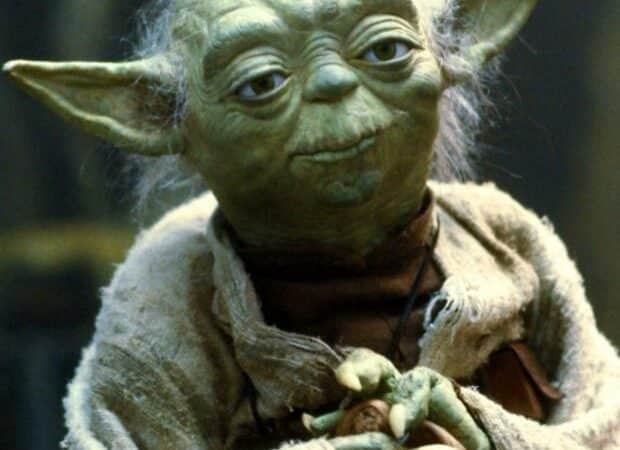 Yoda with hands folded, saying 'Happy birthday to you. May your cake be, and your age a secret it shall remain.'