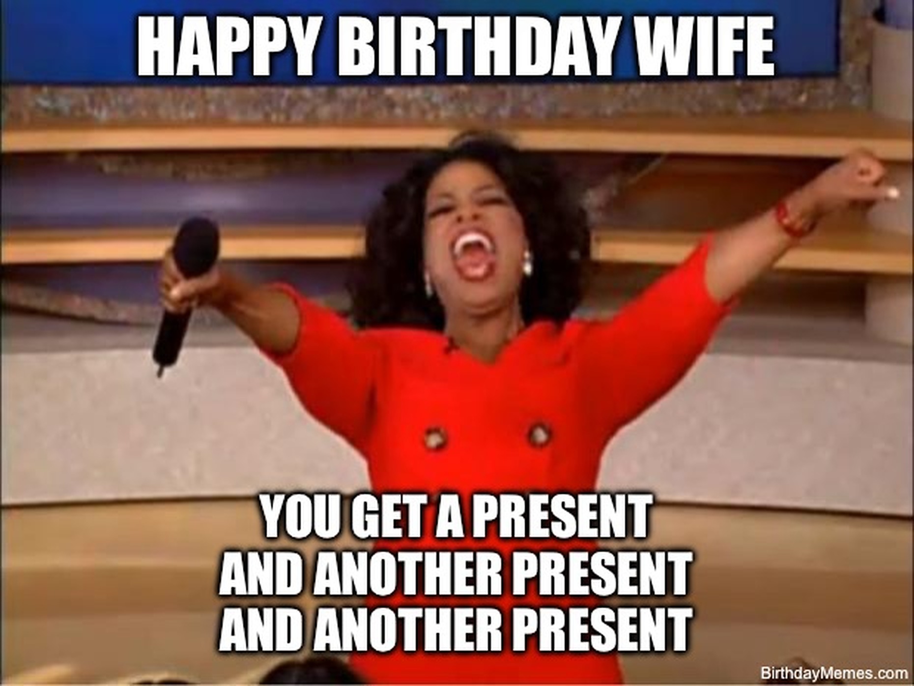 Oprah in a red dress excitedly giving away presents with the text: Happy Birthday Wife. You get a present and another present and another present.